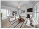 Bright, modern living room with stylish furniture, fireplace, and neutral color palette at 1213 Cotten Farm Dr, Fuquay Varina, NC 27526