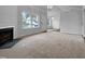 An open living room area offering neutral walls, carpet, and a fireplace at 1213 Cotten Farm Dr, Fuquay Varina, NC 27526