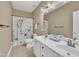 A bathroom with double vanity, modern fixtures, and floral shower curtain at 12404 Beauvoir St, Raleigh, NC 27614