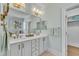 Bathroom with double sinks, natural light, and plenty of cabinet space at 12404 Beauvoir St, Raleigh, NC 27614