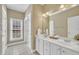 Bathroom with double vanity, sleek fixtures and natural light at 12404 Beauvoir St, Raleigh, NC 27614