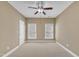 This is a neutral bedroom featuring carpeted floors and large windows for ample light at 12404 Beauvoir St, Raleigh, NC 27614