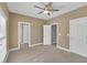 Spacious bedroom with a ceiling fan and multiple entryways at 12404 Beauvoir St, Raleigh, NC 27614