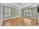 A bright, empty bedroom features neutral walls, hardwood floors and a tray ceiling at 12404 Beauvoir St, Raleigh, NC 27614