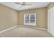 Neutral bedroom with a ceiling fan and large window at 12404 Beauvoir St, Raleigh, NC 27614