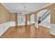 Spacious dining room featuring hardwood floors, chandelier, and arched doorways at 12404 Beauvoir St, Raleigh, NC 27614