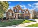 Beautiful two-story brick home featuring a well-kept lawn and a two-car garage at 12404 Beauvoir St, Raleigh, NC 27614