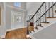Grand foyer with soaring ceilings, hardwood floors, and decorative staircase at 12404 Beauvoir St, Raleigh, NC 27614
