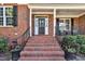 Inviting brick front porch and leaded glass door, complete with seasonal wreath at 12404 Beauvoir St, Raleigh, NC 27614