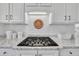 Gas cooktop with white subway tile backsplash and granite countertops at 12404 Beauvoir St, Raleigh, NC 27614