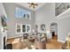 Bright and airy living room with tall windows, fireplace, and hardwood floors at 12404 Beauvoir St, Raleigh, NC 27614