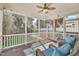Comfortable screened porch features wood flooring, ceiling fan and plush seating at 12404 Beauvoir St, Raleigh, NC 27614