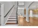 Elegant staircase with hardwood steps and iron railings, leading to open landing at 12404 Beauvoir St, Raleigh, NC 27614