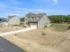 New construction home with a long driveway and adjacent green space at 125 Scotland Dr, Youngsville, NC 27596