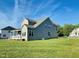 Rear exterior featuring a covered patio and spacious yard with well-maintained landscaping at 125 Scotland Dr, Youngsville, NC 27596