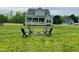 Backyard featuring a covered porch, fire pit with chairs, perfect for outdoor entertaining and relaxation at 125 Scotland Dr, Youngsville, NC 27596