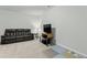Spacious basement featuring a comfortable leather sofa, perfect for movie nights and Gathering gatherings at 125 Scotland Dr, Youngsville, NC 27596