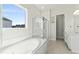 Bright bathroom featuring a soaking tub, glass-enclosed shower, and modern vanity at 125 Scotland Dr, Youngsville, NC 27596