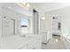 Open Primary bathroom featuring dual vanities, a glass shower, soaking tub, and bright natural light at 125 Scotland Dr, Youngsville, NC 27596