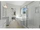 Well-lit bathroom with tiled floors, glass-enclosed shower, and stylish vanities at 125 Scotland Dr, Youngsville, NC 27596