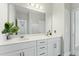 Large bathroom with double sinks, white cabinets, a mirror and modern fixtures at 125 Scotland Dr, Youngsville, NC 27596