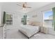 Relaxing bedroom featuring a plush bed, soft carpet, and natural light from multiple windows at 125 Scotland Dr, Youngsville, NC 27596