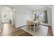 Bright dining room with a classic chandelier and views of the front yard at 125 Scotland Dr, Youngsville, NC 27596