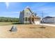 Two-story home featuring a stone facade, covered porch, and attached two-car garage at 125 Scotland Dr, Youngsville, NC 27596