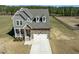 Beautiful exterior showcasing a two-story home with stone accents and a welcoming covered front porch at 125 Scotland Dr, Youngsville, NC 27596