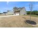 Two-story home featuring a stone facade, covered porch, and long driveway at 125 Scotland Dr, Youngsville, NC 27596