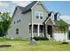 Charming two-story home with a combination of stone and siding with a manicured lawn at 125 Scotland Dr, Youngsville, NC 27596