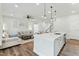 Open-concept kitchen flows to living area; features modern island and stainless appliances at 125 Scotland Dr, Youngsville, NC 27596