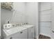 Efficient laundry room with washer, dryer, and shelving for storage and organization at 125 Scotland Dr, Youngsville, NC 27596