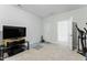 Living room with TV and exercise equipment and carpeted floors at 125 Scotland Dr, Youngsville, NC 27596