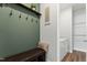 Functional mudroom with storage bench and coat hooks, conveniently located near the laundry at 125 Scotland Dr, Youngsville, NC 27596