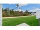 Spacious backyard area with grass, trees, and partial privacy fence at 168 Starlight St, Sanford, NC 27330