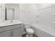 Modern bathroom features a combined tub and shower, a toilet, and vanity with sink at 168 Starlight St, Sanford, NC 27330