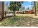 Backyard view of ranch style home with spacious lawn and carport at 1704 Cypress Dr, Henderson, NC 27536