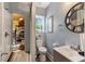 Compact bathroom featuring a modern sink, toilet, and storage shelves, providing a functional and efficient space at 1704 Cypress Dr, Henderson, NC 27536