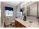 Bright bathroom with dual sink vanity, tile flooring, modern lighting, and a shower with a curtain at 1704 Cypress Dr, Henderson, NC 27536