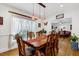 Dining room boasts a large wooden table and chairs, and natural light at 1704 Cypress Dr, Henderson, NC 27536