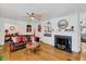 Cozy living room featuring a fireplace, built-in shelves, and hardwood floors at 1704 Cypress Dr, Henderson, NC 27536