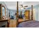 Spacious main bedroom with a four-poster bed, hardwood floors, and plenty of natural light to fill the room at 1704 Cypress Dr, Henderson, NC 27536