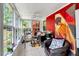 Bright sunroom with large windows, tile flooring, and a decorative red brick wall that provides a unique accent at 1704 Cypress Dr, Henderson, NC 27536