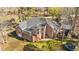 Aerial view of a brick home with a sunroom, shed, and trampoline at 199 Black Cloud Dr, Louisburg, NC 27549