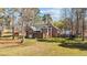 Brick home exterior with sunroom, shed, and backyard trampoline at 199 Black Cloud Dr, Louisburg, NC 27549