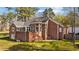 Back exterior of home features a back patio, sunroom, and brick construction at 199 Black Cloud Dr, Louisburg, NC 27549