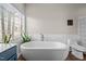 Bright bathroom features a standalone tub, window and toilet at 199 Black Cloud Dr, Louisburg, NC 27549