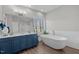 Bright bathroom features a standalone tub, walk-in shower with glass blocks, and a double vanity with a large mirror at 199 Black Cloud Dr, Louisburg, NC 27549