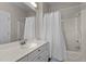 Bathroom with a white vanity, a bathtub with shower, and a mirror at 199 Black Cloud Dr, Louisburg, NC 27549